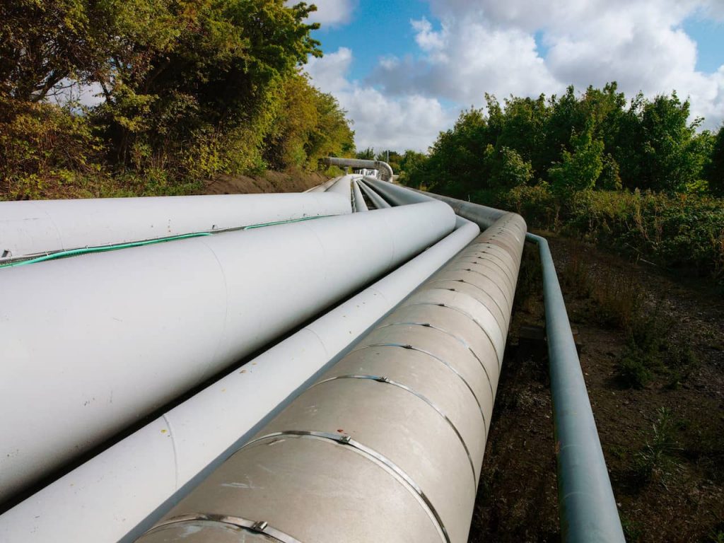 Large pipes running through a forest landscape